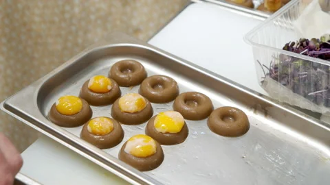 Close-up of male chef hands preparing delicious snacks with egg yolk in the Stock Footage 150975482