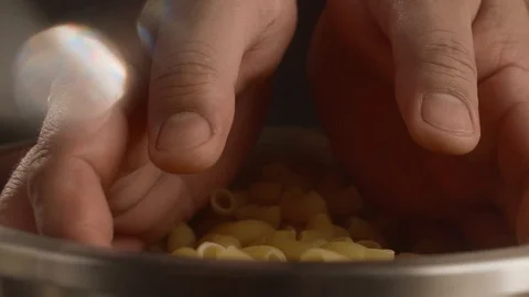 Close-up male chef hands take dry pasta for cooking pasta. Slow Motion video Stock Footage 113739804