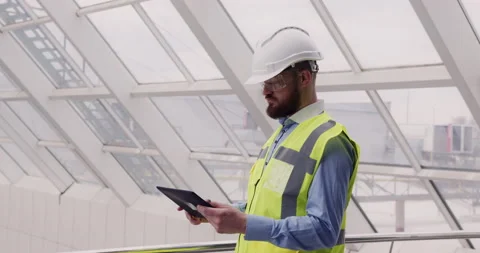 Close up of male chief engineer in hardhat and vest standing inside commercial Video stock 153170244