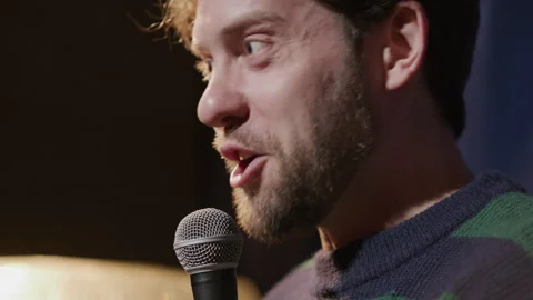 Close Up of Male Comic Telling Witty Story in Mic during Standup Show Stock Footage 333228336