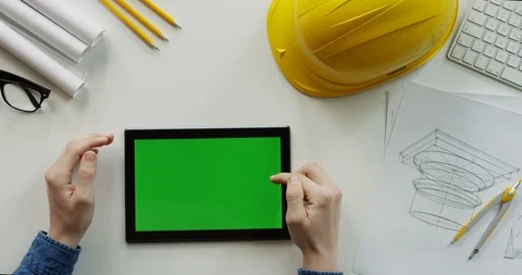 Close up of the male constructor's hands scrolling and tapping on the black Stock Footage 96189510