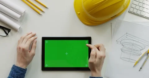 Close up of the male constructor's hands scrolling and tapping on the black Stock Footage 96189799
