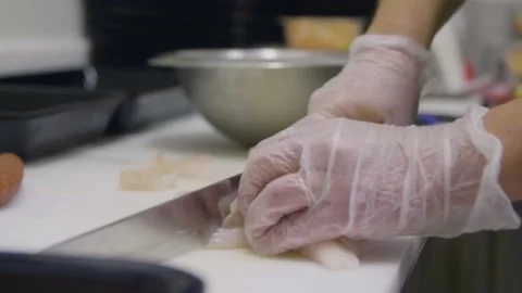 Close-Up Male Cook Dicing Fish in a Professional Kitchen Stock Footage