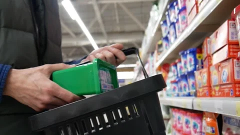 Close-up of a male customer choosing laundry pods in a shopping mall Stock Footage 335516438