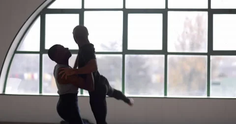Close-up male dancer lifting partner up while dancing in studio Stock Footage 147359327
