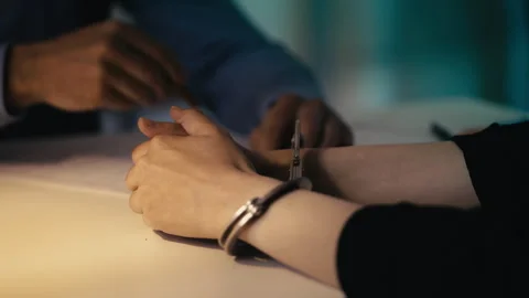 Close-up of a male detective interrogating an arrested woman at police station Stock Footage 302919939