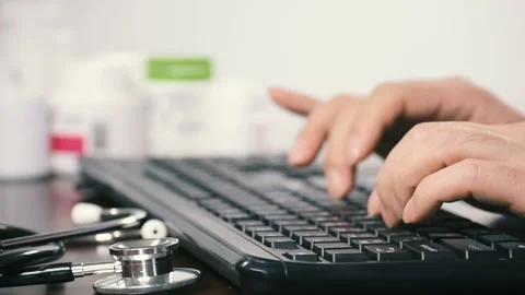 Close-up of a male doctor using a computer keyboard. Stock Footage 96741760