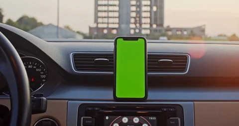 Close-up male driver tapping on smartphone navigator greenscreen mock-up on Stock Footage 116693516