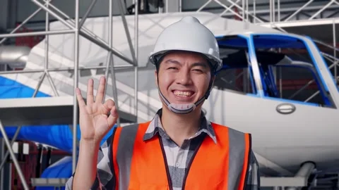Close Up Of Male Engineer Smiling And Showing Okay and Inspecting Helicopter Stock Footage 312126657