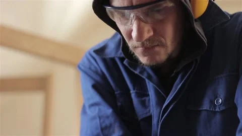Close up male face carpenter worker wearing protection glasses blue overalls 動画素材 88295403