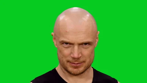 Close-up of male face having tricky plan in mind and flirting on green screen Vídeo Stock 130797059