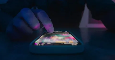 Close up male finger scroll smartphone screen social networks at night. Male Stock Footage