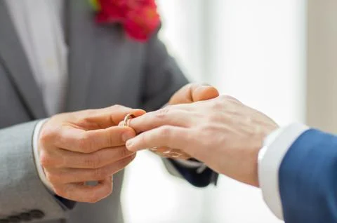 Close up of male gay couple hands and wedding ring Stock Photos