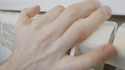 Close Up Male Hand Checking Central Heating Radiator At Home Stock Footage 329402971