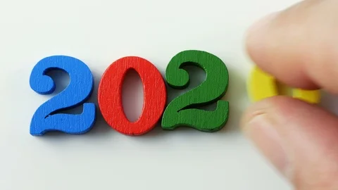 Close up male hand composing number 2020 with colorful wooden figures Stock Footage 122952304