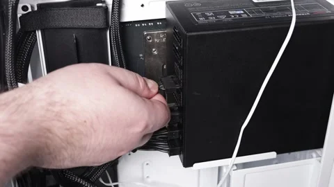 Close-up of male hand connecting modular cable to power supply unit inside .. Stock Footage 305673221