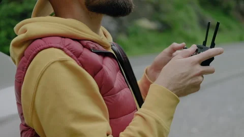 Close up male hand with drone camera remote Man launching a quadcopter Stock Footage 138491072