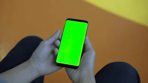 Close up of male hand holding smart phone and reads news. Green screen Stock Footage