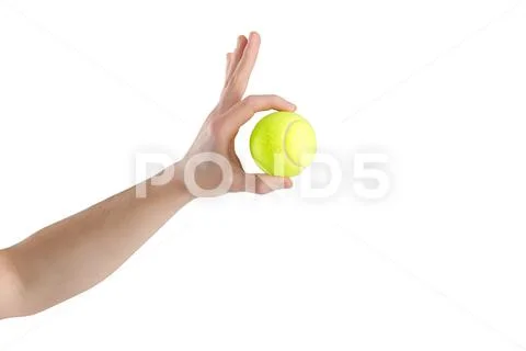 Close-up of male hand holding tennis ball on white background Stock-Fotos