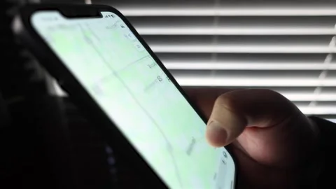 Close up of male hand looking at a map on phone 3 Stock Footage 265811576
