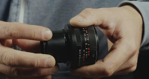 Close-Up Of A Male Hand Mounts A Macro Ring To The Lens. Photographer Vídeos de archivo 121949507