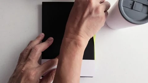 Close-up of male hand opening a notebook on white desk in natural light Stock Footage 309978888