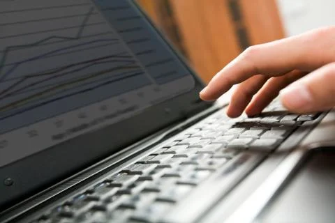 Close-up of male hand over keyboard of laptop during computer work Stock Photos