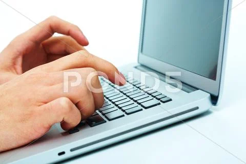 Close-up of male hand over keyboard of laptop during computer work Stock Photos
