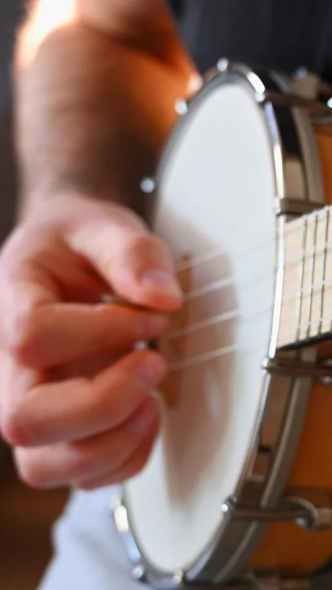 Close-up of Male Hand Picking Strings of Wooden Banjolele Stock Footage 332906900