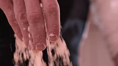 Close-up of male hand pours flour in kitchen. Professional Baker and baking Stock-Footage 151118853