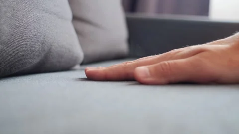 Close-up of male hand pressing light sofa for comfortable sitting at home Stock Footage 251287146