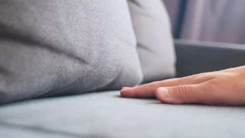 Close up of male hand pressing sofa seat surface Stock Footage 251286695