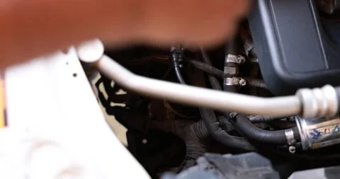 Close up male hand pulling the engine oil dipstick to check lubricant level.. Stock Footage 329744188