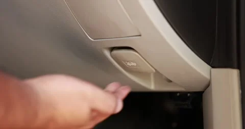 Close up of a male hand pulling the hood release lever inside a car to open.. Stock Footage 329743975