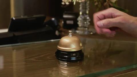Close Up of Male Hand Ringing Service Bell on Hotel Reception Desk Stock Footage 345833396