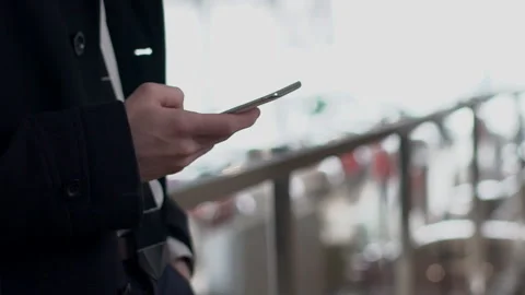 Close up of male hand scrolling the screen of smartphone outside, slow motion. Stock Footage 88534594