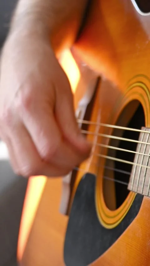 Close-up of Male Hand Strumming Strings on Acoustic Guitar Stock Footage 332906280