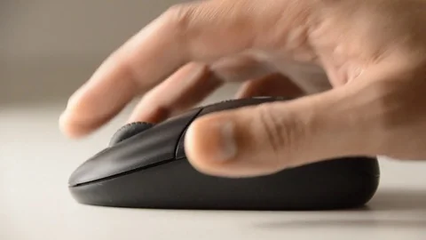 Close up of a male hand using a computer mouse thumb.Playing computer games at n Stock-Footage 70660732