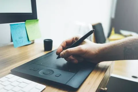 Close-up of male hand using modern computer and stylus Stock Photos