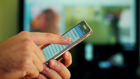 Close-Up of a Male Hand Using a Smart-Phone at Home Stock Footage
