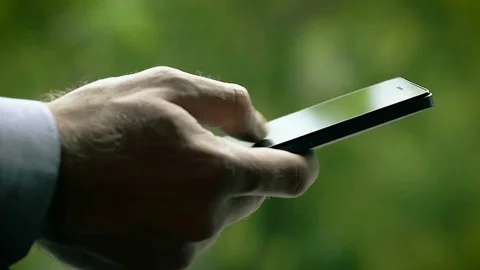Close-Up of Male Hand Using SmartPhone in the Park 스톡 동영상 72582615