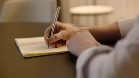Close-up of male hands and notebook of unidentified young writer. Stock Footage 236772494