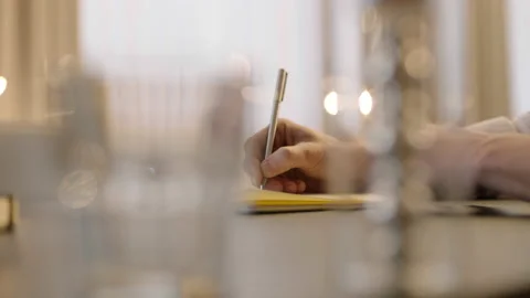 Close-up of male hands and notebook of unidentified young writer. Stockbeeldmateriaal 236772505