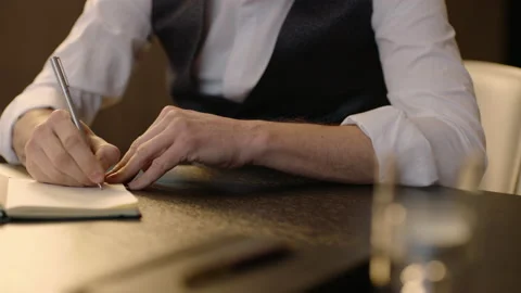 Close-up of male hands and notebook of unidentified young writer. Stock Footage 236772563