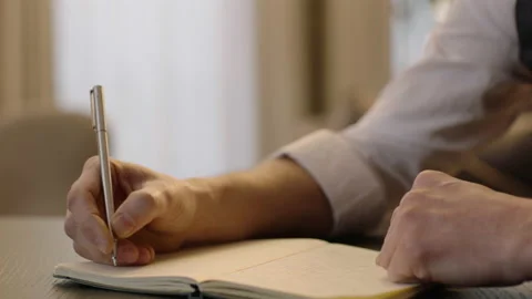 Close-up of male hands and notebook of unidentified young writer. Stock Footage 236772664