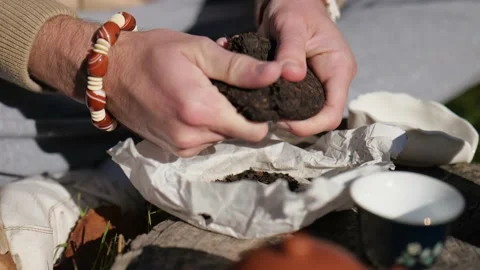 Close-up. male hands break pressed pu-erh tea. chinese tea ceremony concept Stock Footage 229858016