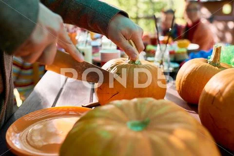 Close-up of male hands carving a pumpkin Stock Photos