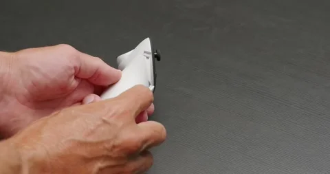 Close-up of male hands changes battery in wireless joystick for VR headset. Stock Footage 258879516