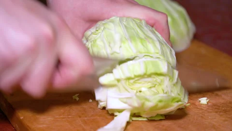 Close up male hands chopped cabbage on wooden board. Stock Footage 249536713