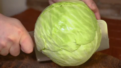 Close up male hands chopped cabbage on wooden board. Stock Footage 254590165